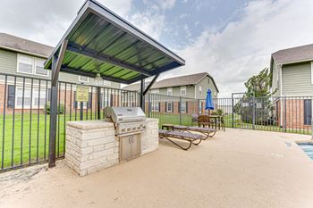 Outdoor grilling station with covered seating area